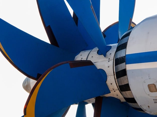 A close-up of a modern small-scale wind turbine blade, highlighting its aerodynamic design and advanced materials, with a clear blue sky in the background.