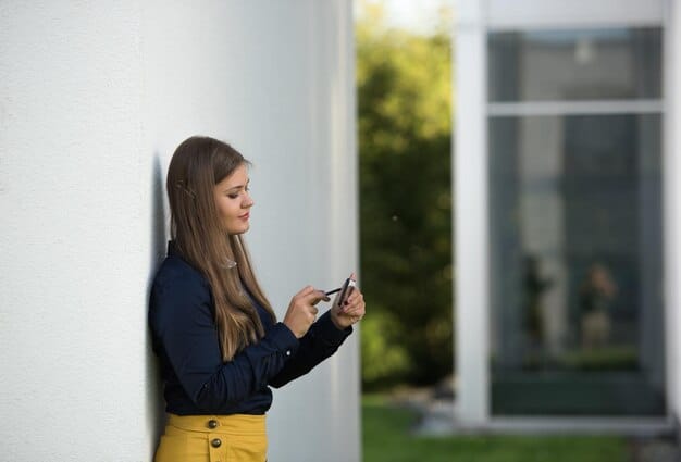 A homeowner adjusting a smart thermostat in a modern home, with solar panels visible on the roof in the background, symbolizing optimized energy consumption and home automation.