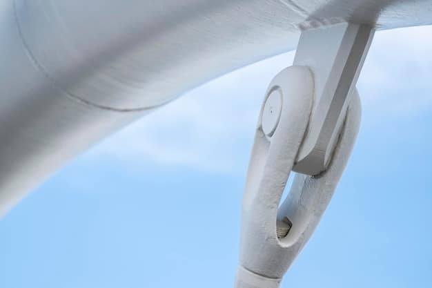 Close-up shot of a wind turbine blade being manufactured in a modern factory, highlighting the composite materials and intricate construction techniques used. Workers in cleanroom suits are visible, ensuring quality control.