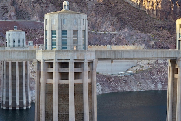 A side-by-side comparison of a traditional large dam and a run-of-river hydropower system, highlighting the differences in environmental impact. The run-of-river system should be shown with minimal disruption to the natural river flow and surrounding habitat.