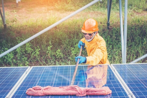 A person using a soft brush and water to clean solar panels on a rooftop, with safety equipment visible (harness, gloves). The focus is on the cleaning process and the equipment used.