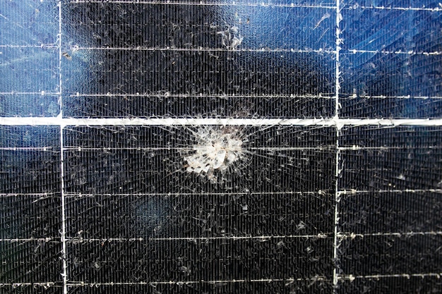 A close-up shot of a damaged solar panel with visible cracks and wear, emphasizing the importance of regular inspections and maintenance.