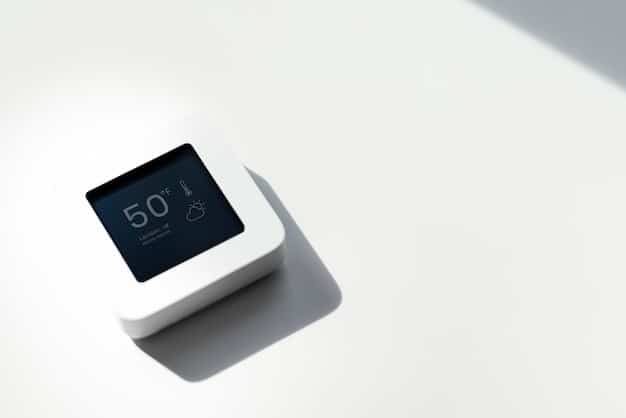 Close-up of a smart thermostat installed on a wall, displaying energy usage statistics and temperature settings, highlighting energy-efficient home automation.