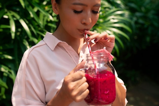 A person using a reusable metal straw to drink a smoothie from a glass jar, with a focus on the eco-friendly materials and sustainable lifestyle choice.