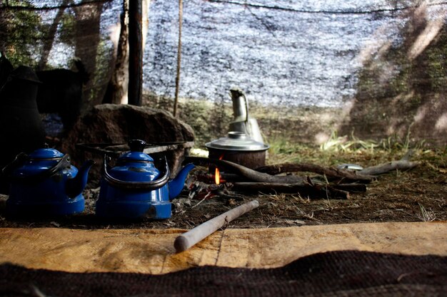 A rural community in a developing country, using a newly installed clean cookstove. The scene suggests reduced deforestation and improved health.