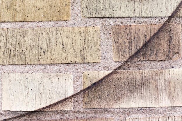 A close-up of a wall being constructed with hempcrete blocks, showcasing the texture and natural appearance of the material.