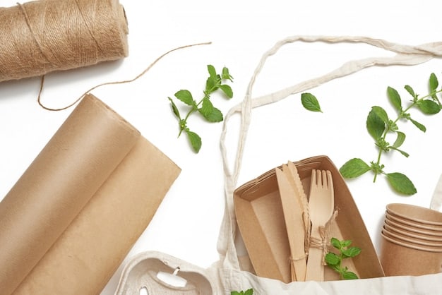 A diverse array of sustainable packaging options, including compostable bags made from plant-based materials, reusable containers, and packaging crafted from recycled cardboard.