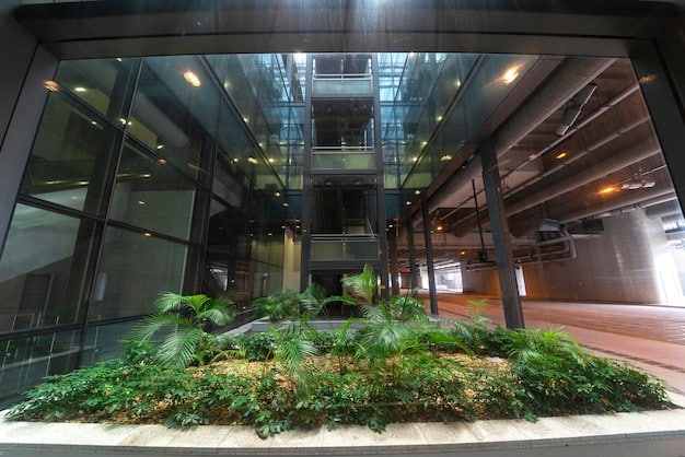 An interior shot of a LEED v5 certified commercial building, showcasing natural light streaming through energy-efficient windows and illuminating a modern, open-plan office space. The image should highlight sustainable design elements such as recycled materials, indoor plants, and ergonomic furniture. The overall impression should be one of a bright, healthy, and productive work environment.