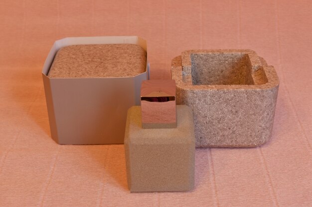 A close-up shot of a variety of biodegradable packaging materials, including recycled cardboard, mushroom packaging, and seaweed-based pouches. Textures and natural colors are highlighted to emphasize the eco-friendly nature of these alternatives.