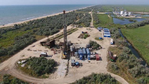 An aerial view of an offshore wind farm under construction, showing the turbines being installed in the ocean. The image should capture the scale of the project and the complexity of the engineering involved.