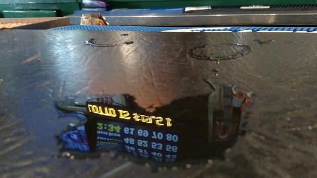 A close-up shot of a high-tech sensor monitoring real-time water quality data, displaying graphs and charts on a digital interface. The sensor is submerged in a clear water sample, highlighting the precision and accuracy of the monitoring technology.