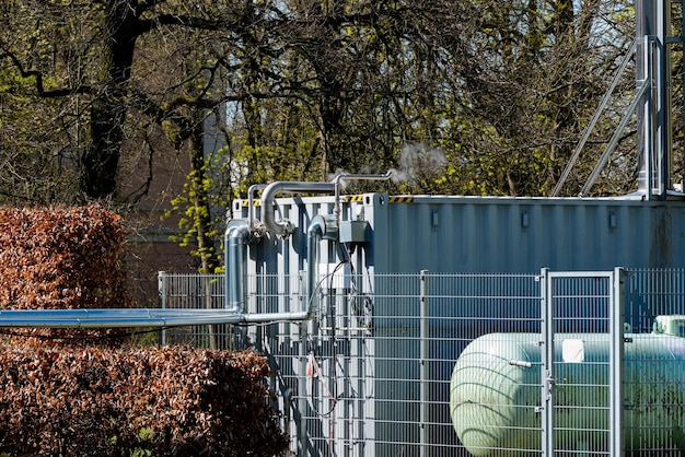 A rooftop rainwater harvesting system with multiple collection tanks, filters, and pipes connected to a residential building. Solar panels are visible nearby, highlighting the sustainable and eco-friendly nature of the system.