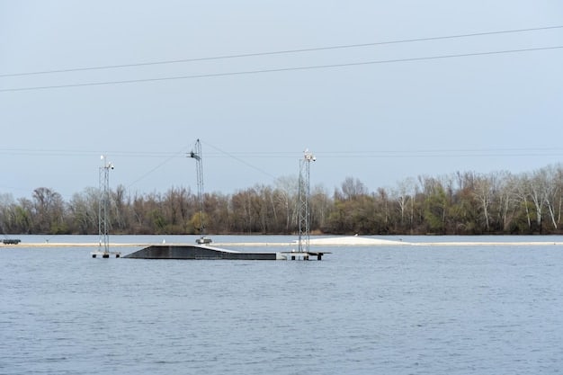 A flooded electrical substation with water reaching critical equipment during a coastal storm, demonstrating the potential for widespread power outages due to hurricanes. Debris and floating objects are visible in the water.