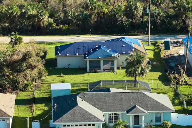A solar panel installation in a residential neighborhood, depicting the decentralization of energy production and the creation of local jobs. Workers are installing the panels on rooftops, demonstrating the hands-on nature of the renewable energy industry and its direct impact on community employment.