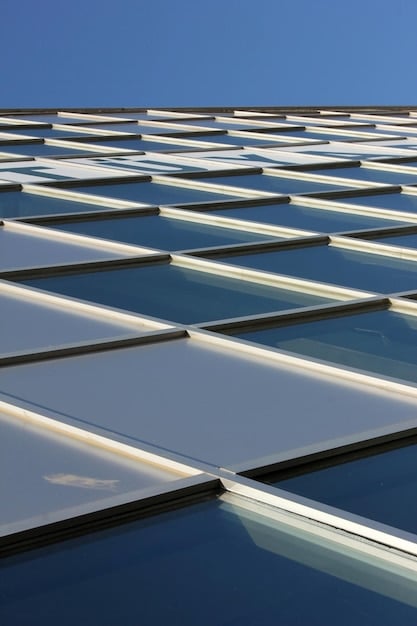 A detailed image of a bifacial solar panel mounted on a rooftop, showing sunlight reflecting off a white, reflective surface onto the back of the panel. The image clearly illustrates how the technology captures light from both sides.