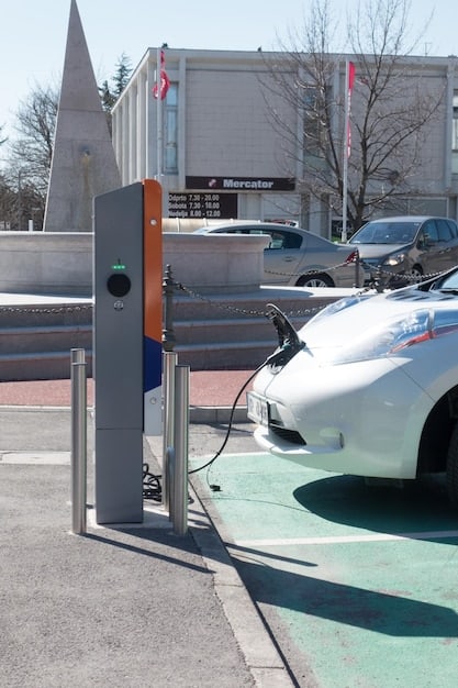 A modern electric vehicle charging station in a bustling urban setting, with several EVs plugged in and charging. The image should highlight the growing adoption of electric vehicles and the importance of charging infrastructure.
