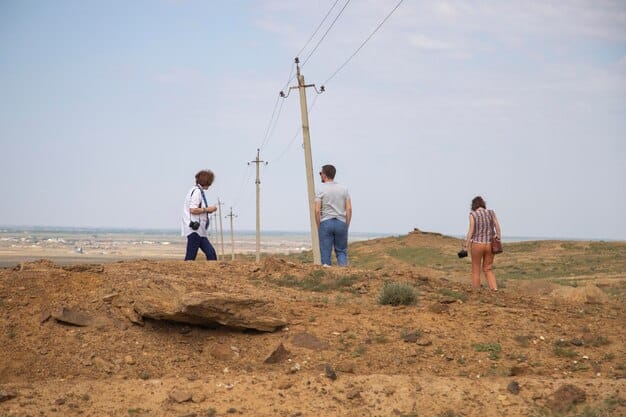 A group of workers repairing a downed power line in a rural area after a severe storm, showcasing the challenges and costs associated with restoring energy infrastructure in the aftermath of extreme weather events.