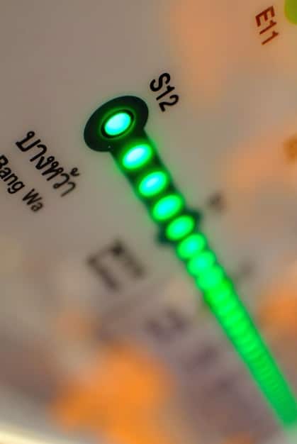 A close-up of a smart meter displaying real-time energy usage in a household, illustrating the concept of energy efficiency and cost savings through monitoring and optimization.